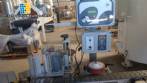 Automatic self-adhesive labeling machine for cylindrical bottles