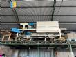 Automatic baling machine with shrink tunnel for bottles and jars in bales.