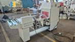 L-shaped packaging sealer with semi-automatic shrink tunnel.