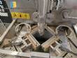 Vertical wrapping machine for triangular format