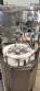 Bottle and jar screwing machine with automatic cap feeding system