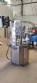 Bottle and jar screwing machine with automatic cap feeding system