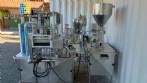 Delgo rotary bottle and jar filling machine for pasty, sweet, and dairy products.