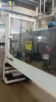 Labeling machine with steam sleeve tunnel and bottle baler