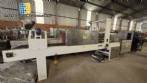 Labeling machine with steam sleeve tunnel and bottle baler