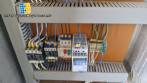 Labeling machine with steam sleeve tunnel and bottle baler
