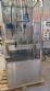 Labeling machine with steam sleeve tunnel and bottle baler