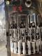 Zegla rotary filling machine with rinser and three-block capping system.